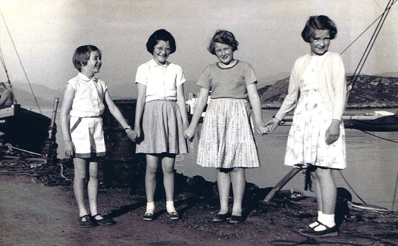 1960 ish - Down the Pier, in front of the White Heather Hotel from left to right:  Jane Forsyth, Janette MacPherson, Caroline Soper, Ann Robertson with Big Finlay on the bow of the Sweet Home in the background